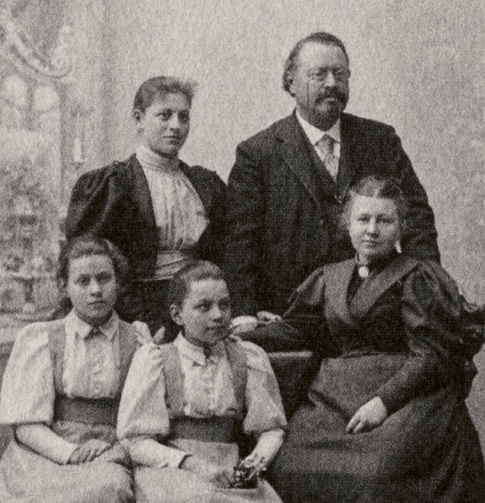 Anna Charlotta Sebenius sitting to the right, surrounded by her husband and three daughters.