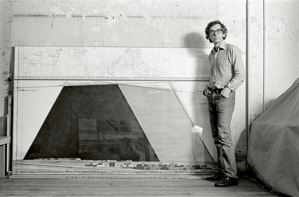 Christo in his studio with a preparatory drawing for The Mastaba. New York City, 1984.
Photo: Wolfgang Volz. © 1984 Christo and Jeanne-Claude Foundation